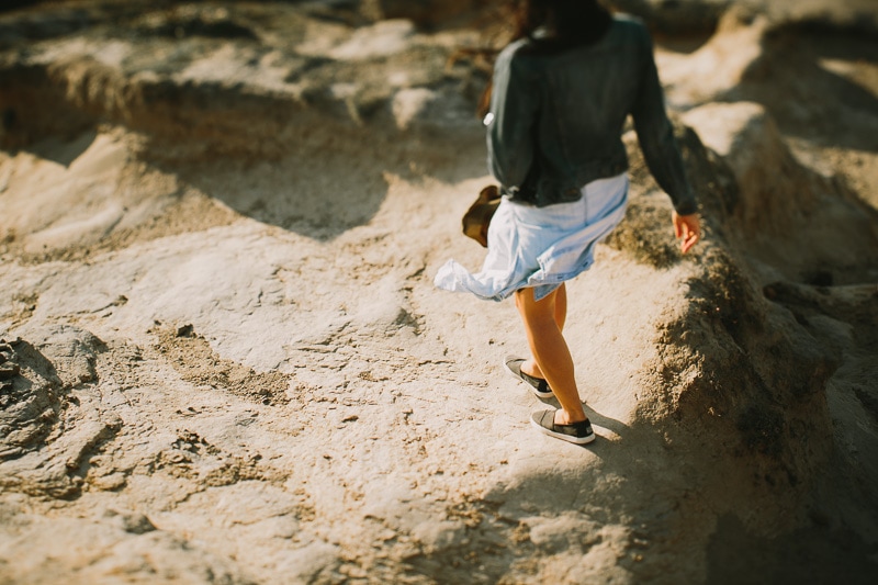 view of girls legs walking on rocks