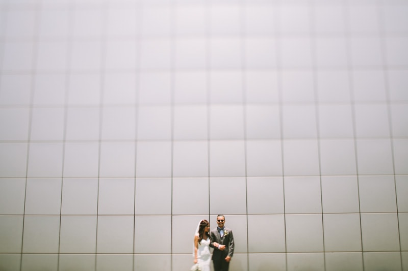 couple standing in front of gray wall