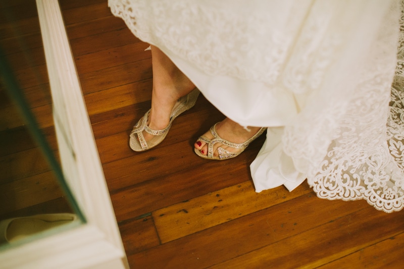 bride putting on wedding shoes
