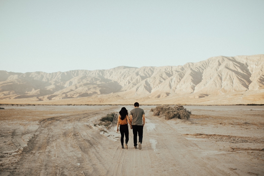 couple walking on a dry lake bed