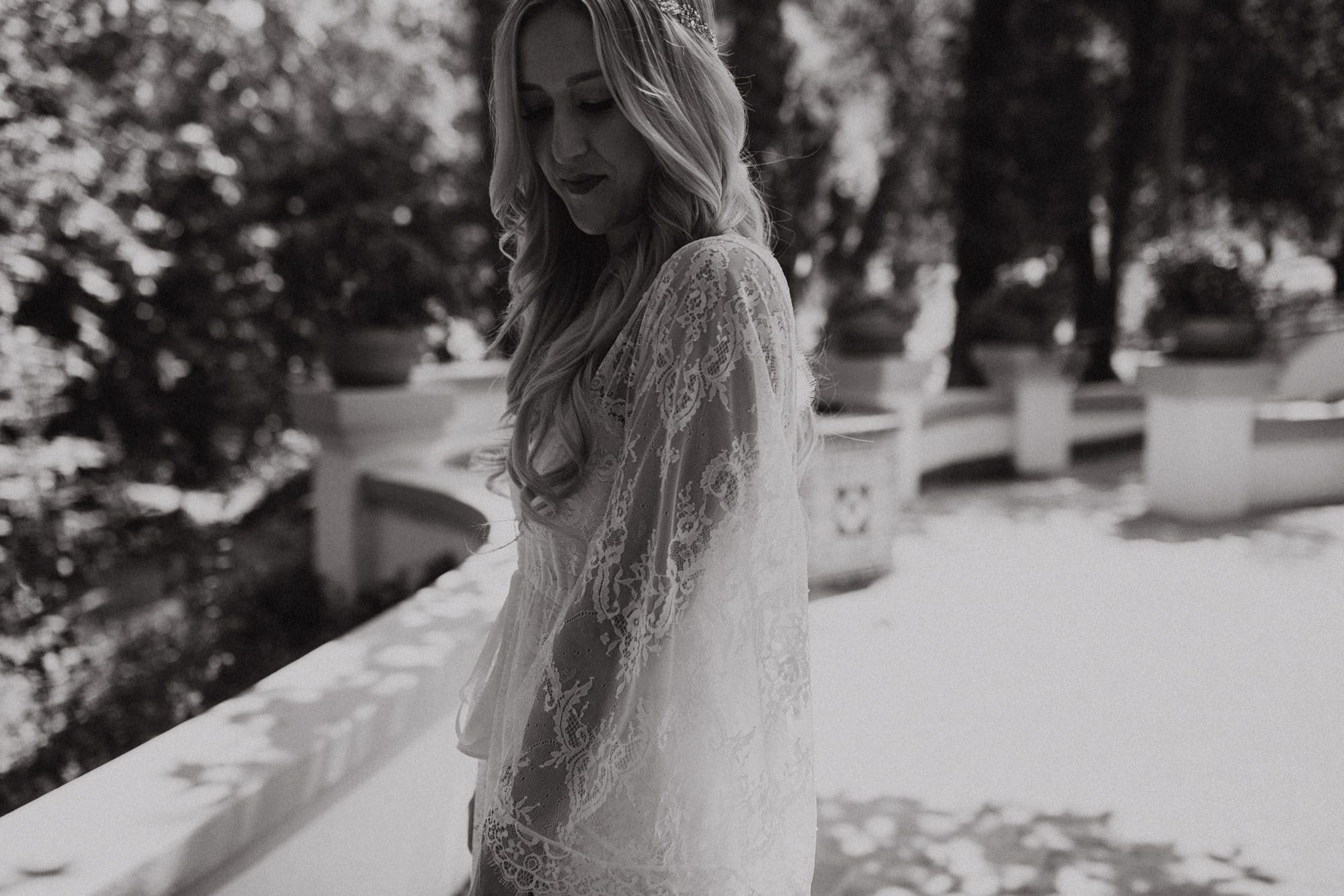 bride wearing a lace robe while getting ready