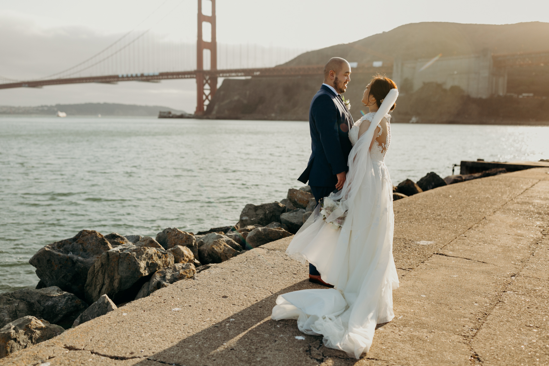 bride and groom portraits with golden gate bridge behind them