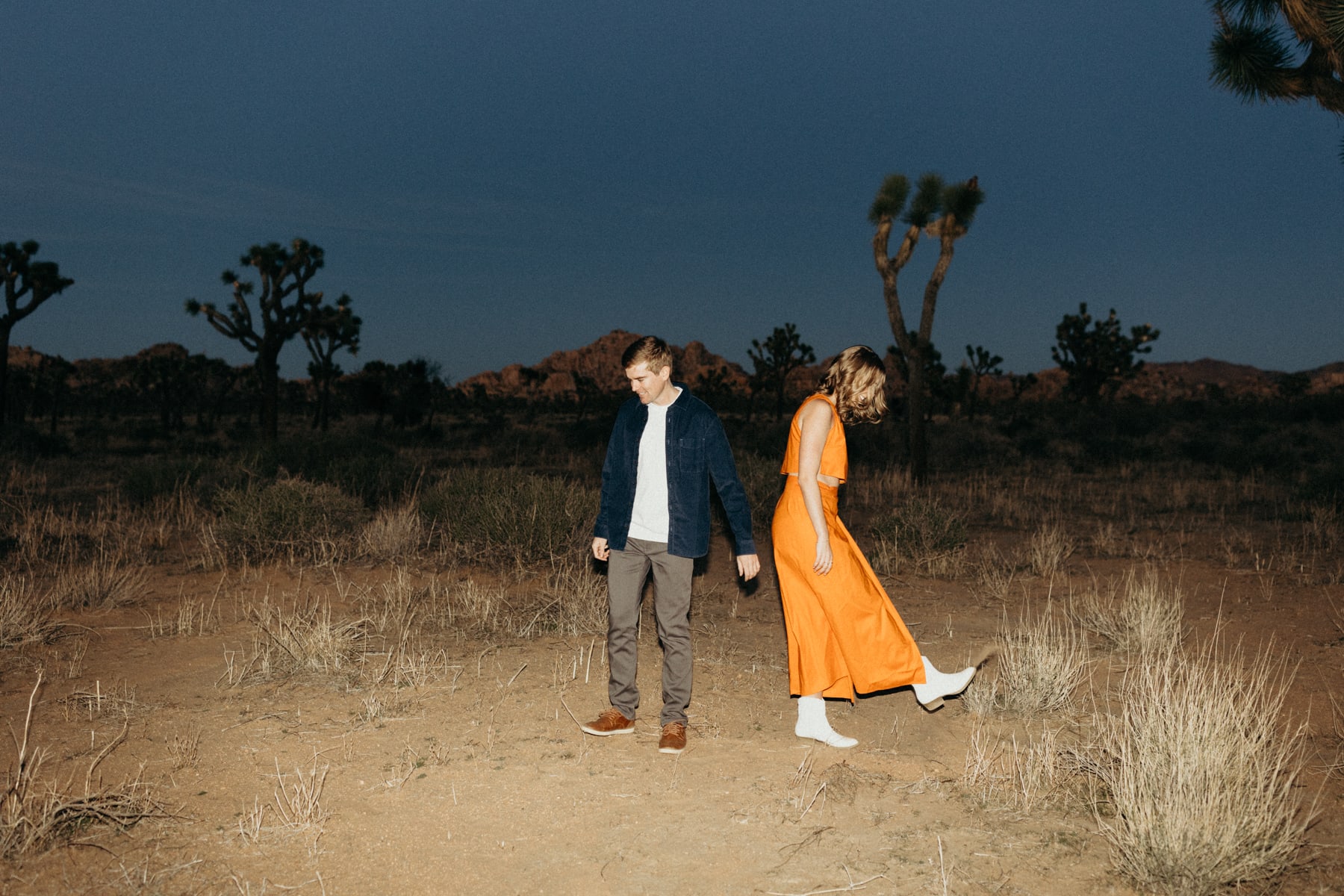 couple roaming in joshua tree with flash photography